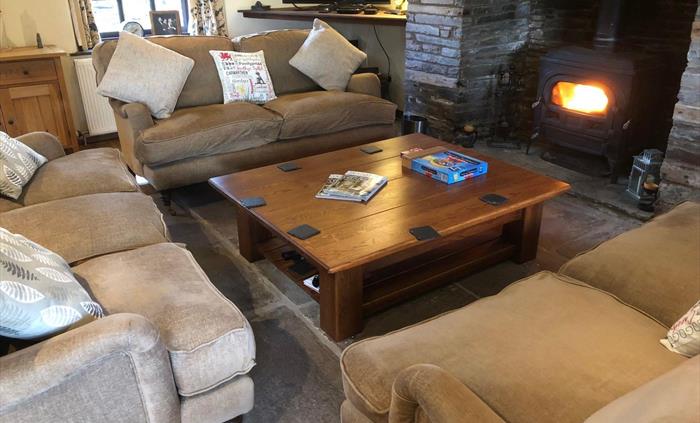 The Farmhouse at Hilltops Brecon Holiday Cottages has a ample sofas, a log-burner and fully fitted kitchen